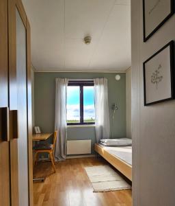 a small bedroom with a bed and a window at Aurora Mountain Cabins & Hostel in Lannavaara