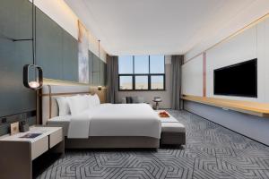 Letto o letti in una camera di 东莞凤岗众恒隆逸扉酒店