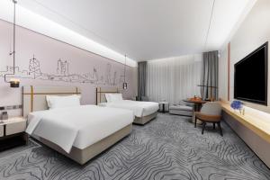 Letto o letti in una camera di 东莞凤岗众恒隆逸扉酒店