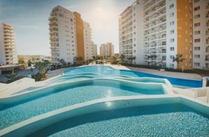 a large swimming pool with two tall buildings at Andreanius Caesar Resort & Spa Studio with Niche, Stunning Balcony View in Iskele