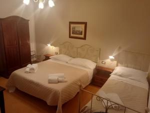 a bedroom with two beds with towels on them at I Tetti di Girgenti in Agrigento
