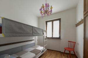 a bedroom with a bunk bed and a chandelier at il larice d' oro in Sueglio