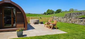 a gazebo with a table and chairs in a yard at Ribblesdale Pods in Horton in Ribblesdale