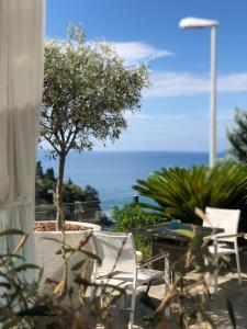 a view of the ocean from a patio with chairs at Senator in Ulcinj