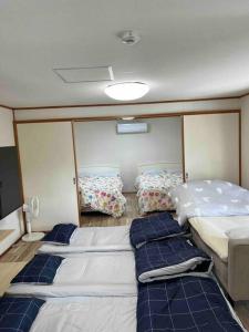 a room with three beds on a boat at 駅徒歩２分の貸切一軒家【Villa Kokusai】 in Naha