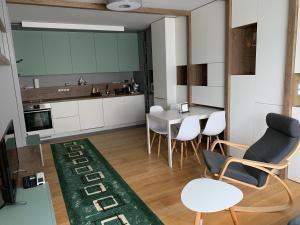 a kitchen and dining room with a table and chairs at Niko's deluxe apartment in Sofia