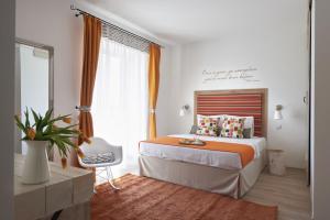 a bedroom with a bed and a desk and a window at Villa Millennium in Balatonalmádi