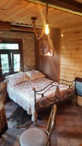 a bedroom with a bed in a log cabin at Babie lato . in Brudnów
