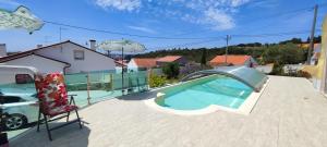 a view of a swimming pool with a chair and a van at Kyrios Lounge Studio with use of private pool in Carrascal