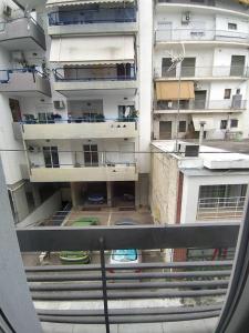 a view of an apartment building from a window at Cherry - HappyHostGr - Downtown Apartment in Volos