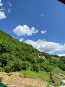 a view of a hill with a house on it at Bizim O'ra Küme Evleri & Bungalov in Macka