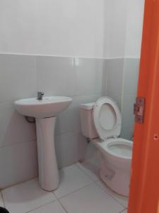 a bathroom with a toilet and a sink at WJV INN NAGA in Tina-an