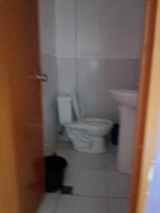 a bathroom with a toilet and a sink at WJV INN NAGA in Tina-an