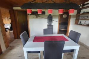 a white table with chairs and a red napkin on it at Butterfly in Saint-Martin