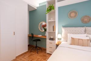 a bedroom with a bed and a desk at Adela's 1 BR & Living room in Athens
