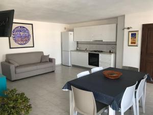 a kitchen and living room with a table and chairs at Coral Bay Suite Gallipoli in Gallipoli
