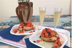 two plates of food on a table with drinks at Coral Bay Suite Gallipoli in Gallipoli