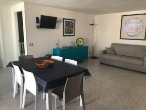 a living room with a table and chairs and a couch at Coral Bay Suite Gallipoli in Gallipoli