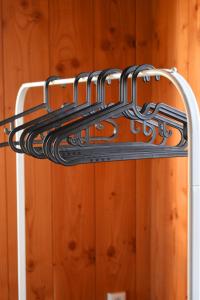 a metal towel rack in a room with a wooden wall at Den Hooimijt in Kats