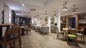 - un restaurant avec des tables et des chaises dans une salle dans l'établissement Apartma Gea, Terme Olimia, à Podčetrtek