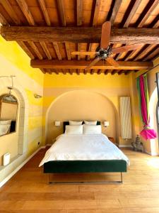a bedroom with a bed with a ceiling fan at Green Escape Guesthouse with Pool in Villa in Florence