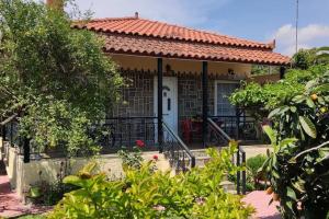 a small house with a red tile roof at Eretria vacation house in Eretria