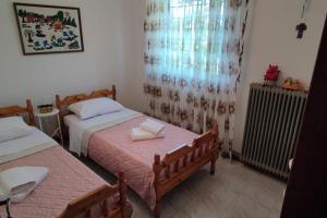 a bedroom with two beds and a radiator at Eretria vacation house in Eretria