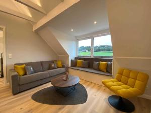 a living room with a couch and a table at DRIEHOF Panorama Apartment Apt 8 in Tecklenburg