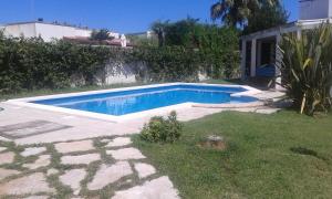 a swimming pool in a yard next to a house at villa Annarè in Torre dell'Orso