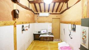 a room with a bed and a desk in it at Beautiful Garden Fine Day House in Jeonju
