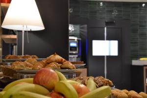 a bunch of different types of pastries and fruit on plates at Elite Hotel & Spa in Mestre