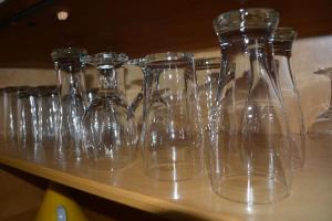 a row of clear glasses sitting on a table at Appartement-terrasse parking privé Meublé de Tourisme 4 étoiles in Belfort