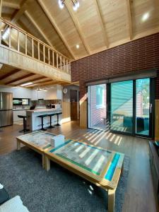 a large living room with a glass table in it at Sodamhyang Pension in Jeju