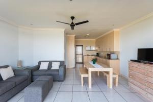 a living room with a couch and a table at Boulder Bay 9 in Ballito