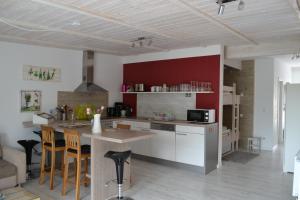 a kitchen with white cabinets and a table with chairs at Strandhof Holnis in Glücksburg