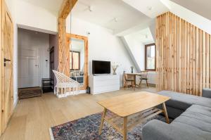 a living room with a couch and a table at Homewell Apartments Wilson Park II in Poznań