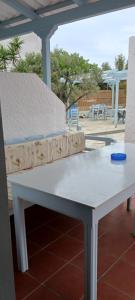 a white table with a couch on a patio at Elia in Skala