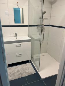 a bathroom with a shower and a sink at Apartament Porta Mare Dziwnów in Dziwnów