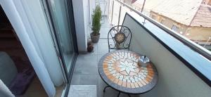a table and a chair on a balcony at Riella Home in Szombathely