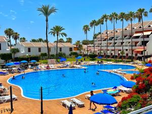 a large swimming pool with people in a resort at Parque Santiago 2 Pure Home Tenerife in Arona