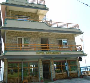 a building with a hotel entrance with a balcony at Hotel Sarangkot in Pokhara