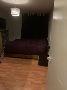 a bedroom with a bed and a wooden floor at 1 bedroom garden flat zone 2 in London