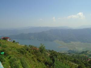 a view of a lake on top of a hill at Hotel Sarangkot in Pokhara