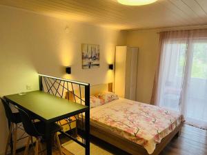 a bedroom with a bed and a table and a desk at Apartment Bagaric in Stari Grad