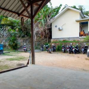 a group of motorcycles parked in front of a building at Join Homestay in Kuta Lombok