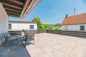 a patio with two chairs and a table at Moderne Ferienwohnung in Lorch in Lorch