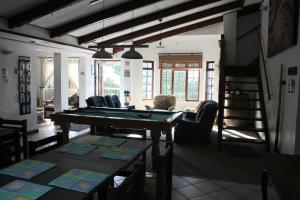 a living room with a pool table and chairs at Whalers Guest House in Hermanus