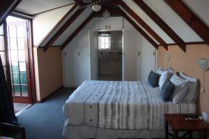 a bedroom with a large bed in a room at Whalers Guest House in Hermanus