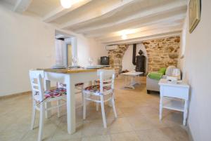 a kitchen and living room with a table and chairs at Holiday Home Nono Frane in Lindar