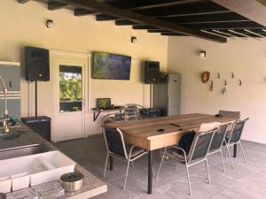 a room with a large wooden table and chairs at Spinning la Divici in Divici